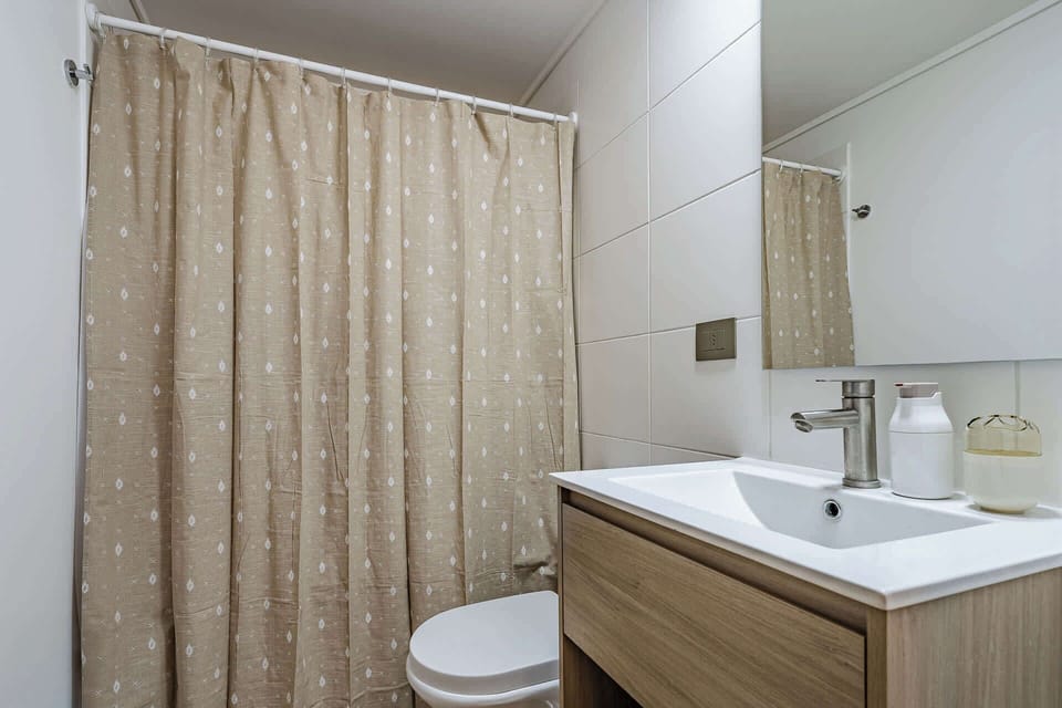 Modern bathroom with sleek fixtures and a calming beige palette, perfect for a refreshing start to your day.