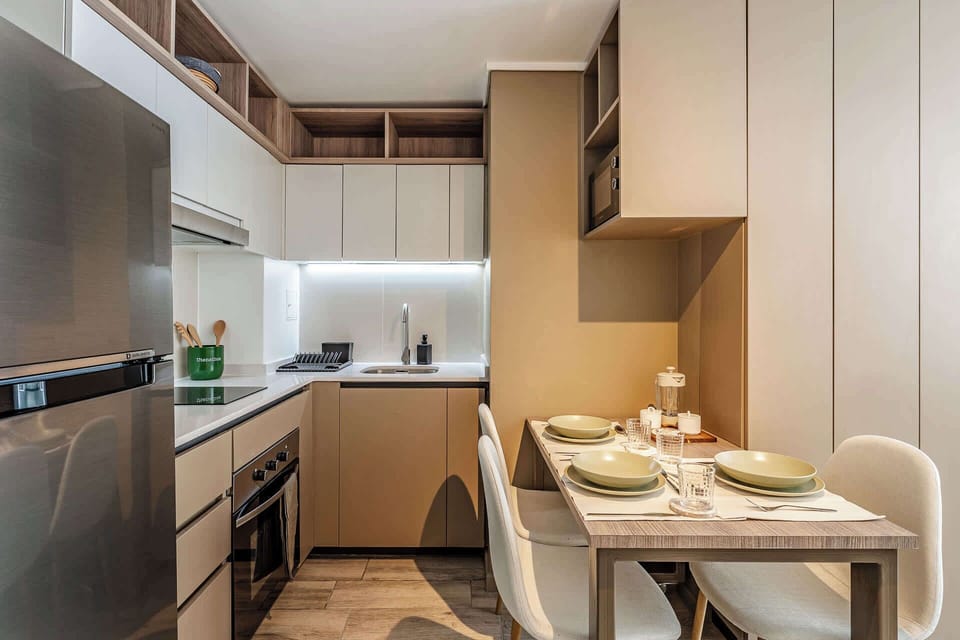 Cozy and modern kitchen with dining area, perfect for intimate meals and culinary adventures.