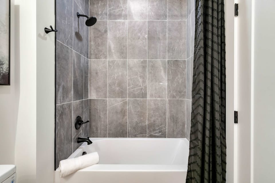 Enjoy a spa-like retreat with sleek tiles and a refreshing rain shower!