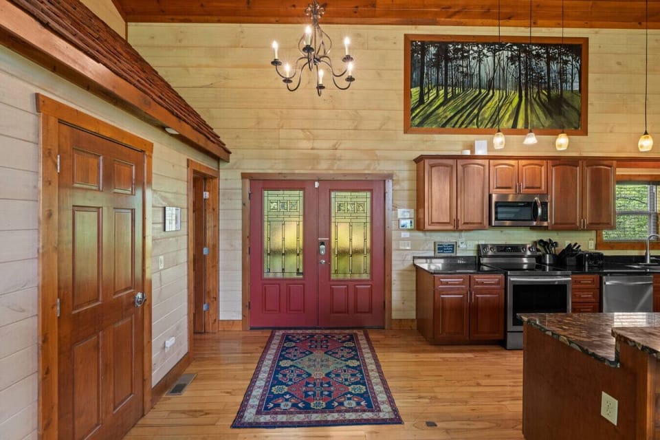 The double-door entryway opens into a polished kitchen with stainless appliances, ample cabinetry, and easy access to the great room.
