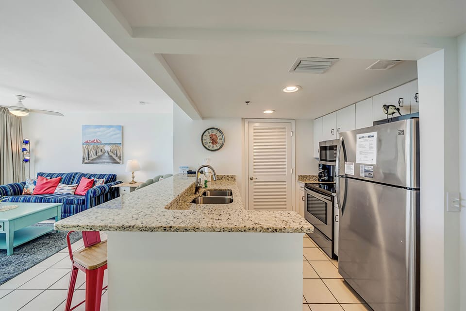 The fully equipped kitchen features granite countertops, stainless-steel appliances, and has everything you need to prepare meals for family & friends.