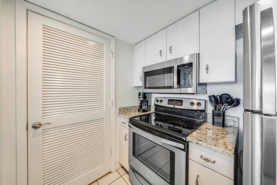 The fully equipped kitchen features granite countertops, stainless-steel appliances, and has everything you need to prepare meals for family & friends.