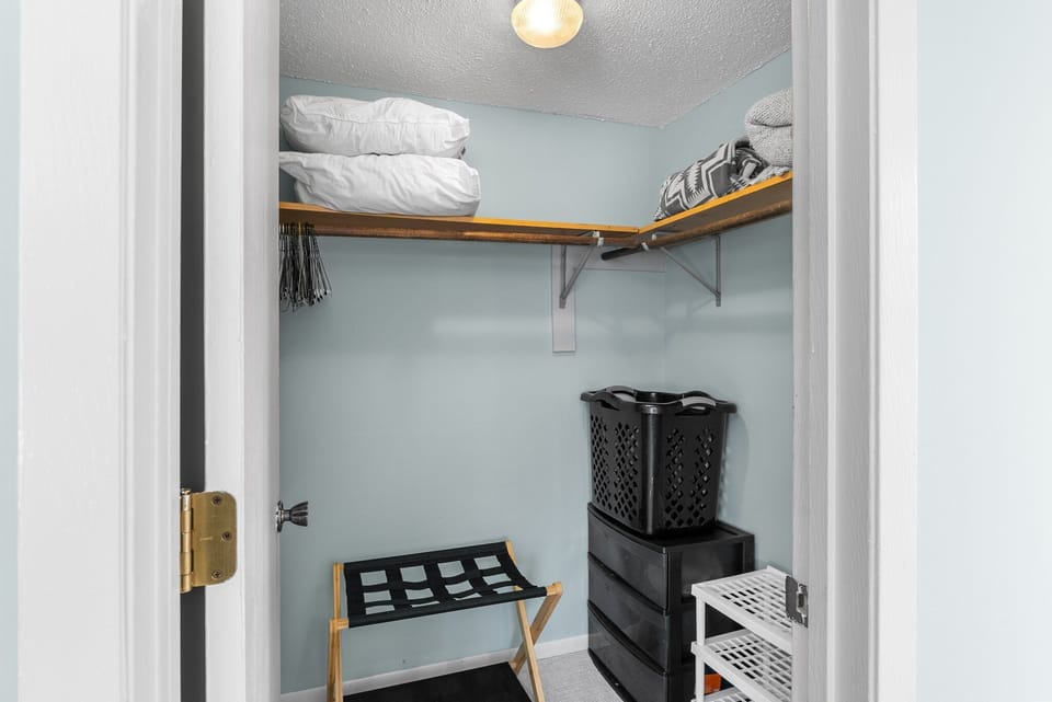 Spacious closet with luggage rack