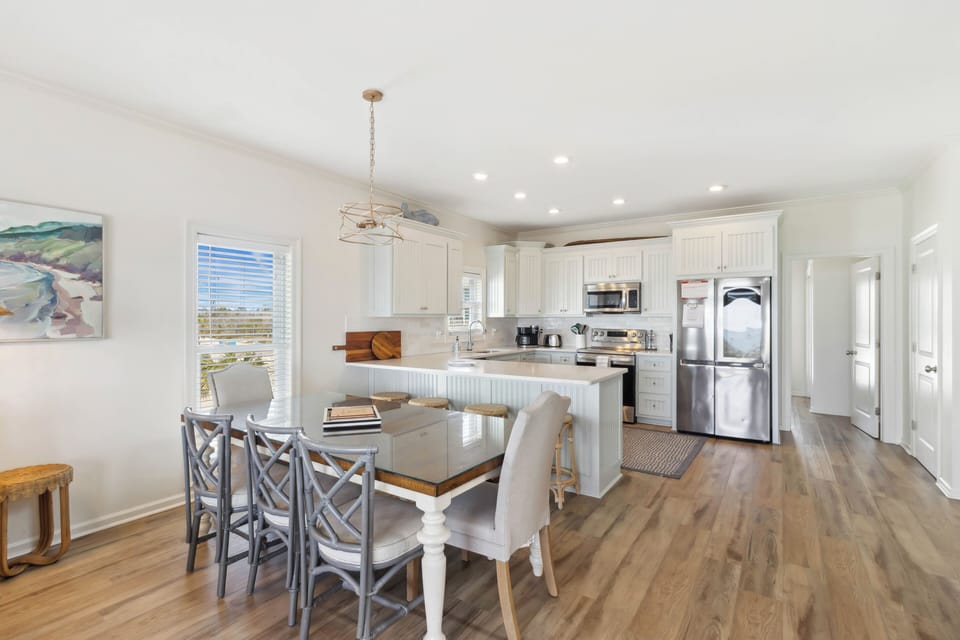 Dining table has seating for 8 and the breakfast bar has 4 barstools