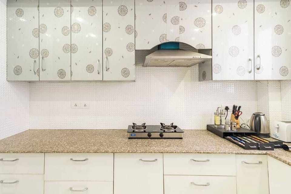 A luxurious, state-of-the-art kitchen featuring high-end stainless steel appliances , marble countertops , and custom cabinetry -parfait street