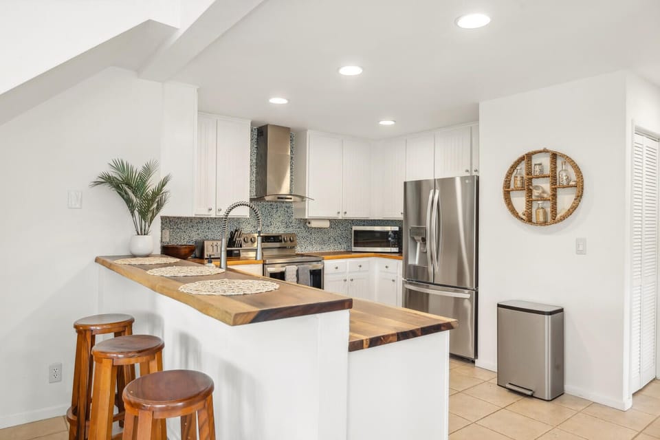 Newly remodeled kitchen with acacia wood counter tops and new appliances