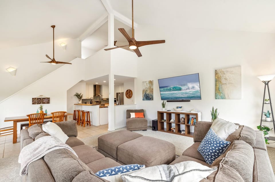 Open-concept main living area with dining, living and kitchen with bar seating