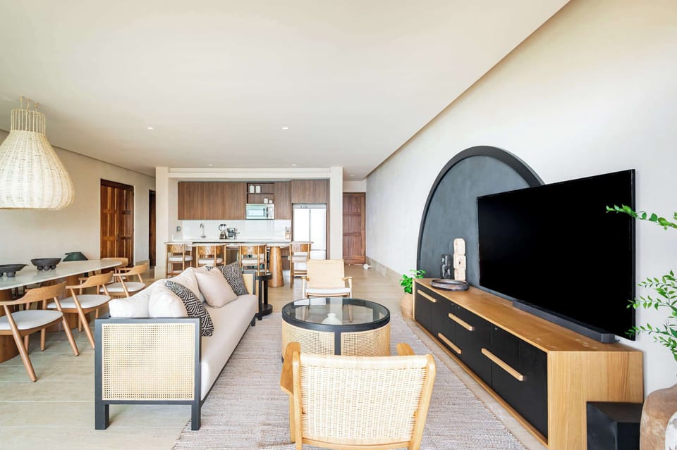  The room is decorated with a few potted plants and textured vases, adding a touch of natural elements. 