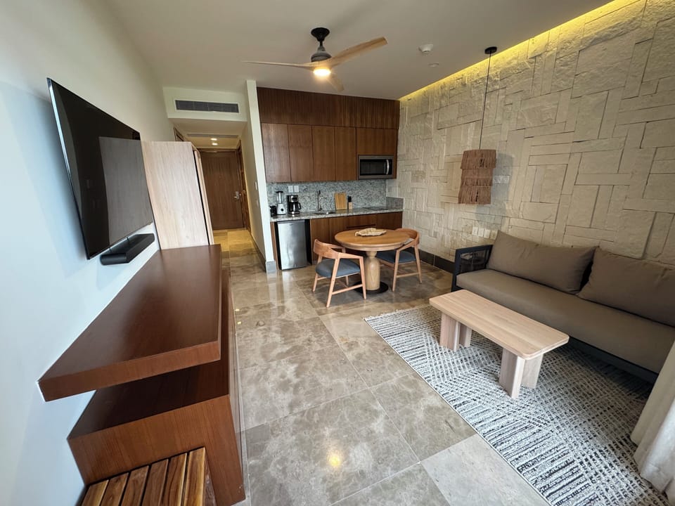 Presidential Suite | Living area | 55-inch flat-screen TV with cable channels, foosball, table tennis