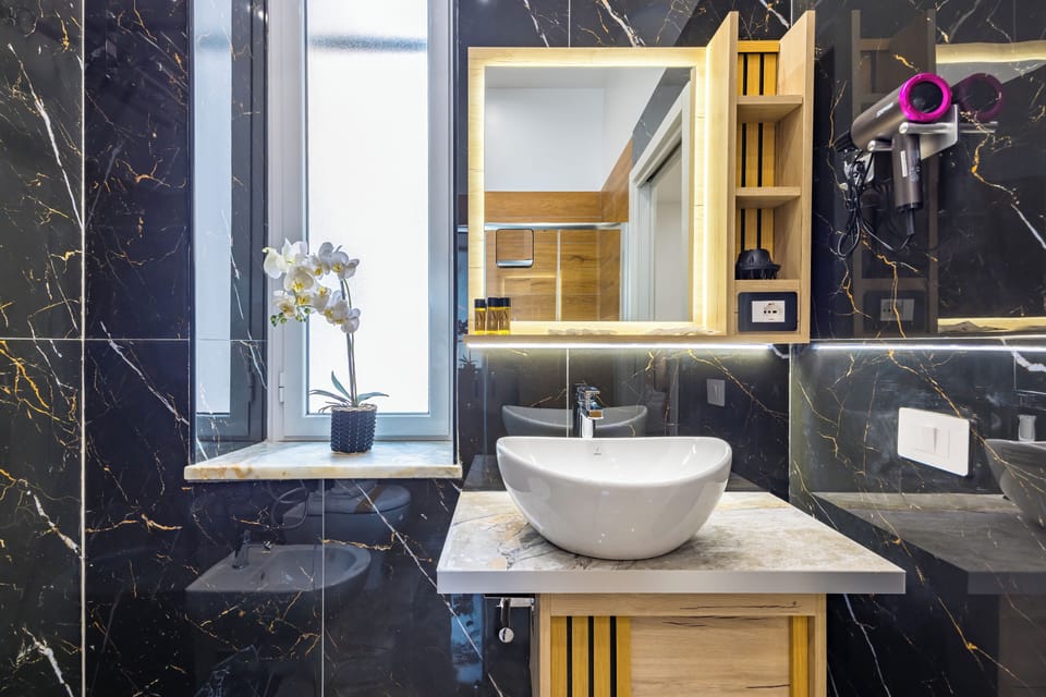 Family Quadruple Room | Bathroom | Shower, hair dryer, slippers, bidet