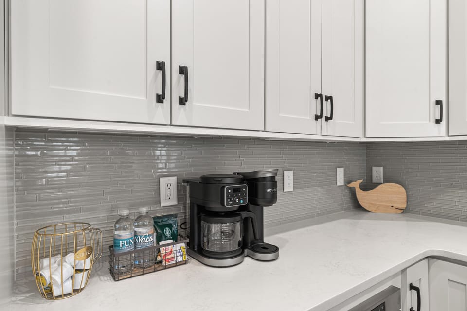 Start your mornings right with fresh coffee from your private kitchen's sleek countertop, complete with modern appliances and stylish finishes.