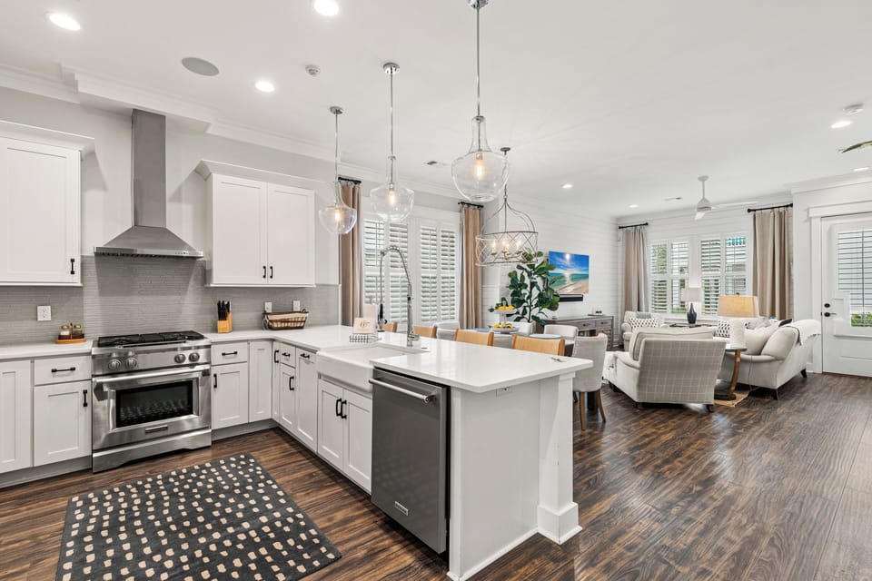 Step into your stylish open-concept retreat where sleek pendant lights illuminate the modern kitchen island, perfect for morning coffee or evening wine with friends.