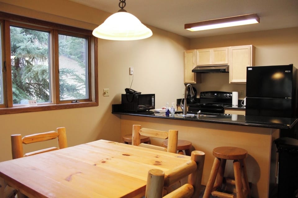 Gather for easy meals in a bright, practical kitchenette.