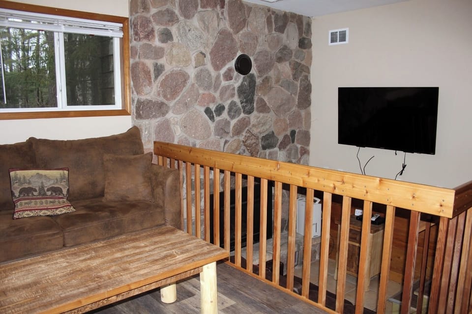 Lounge comfortably beside the stone hearth in a rustic retreat.