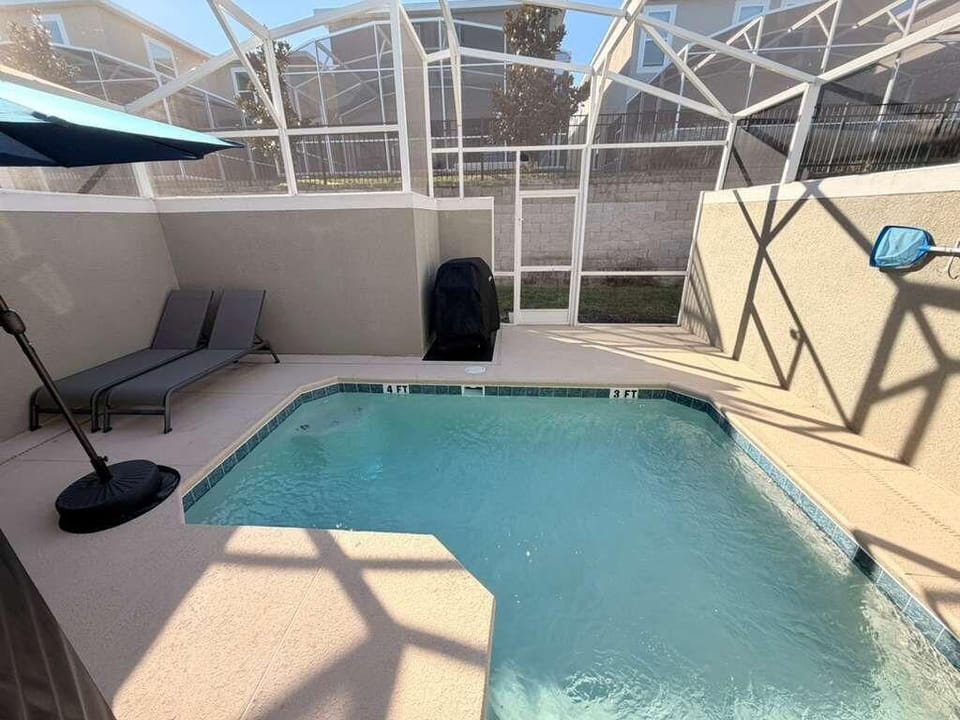 Secluded screened pool patio with lounge and grill area