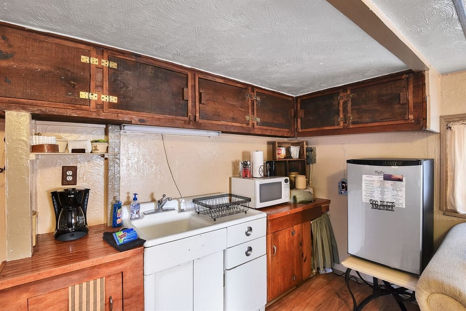 The Bunk House - The functional kitchenette is equipped with essentials to whip up a quick breakfast and compliment to the BBQ cooked outside. Coffee maker, cooking utensils, dishes, microwave, refrigerator, and toaster.