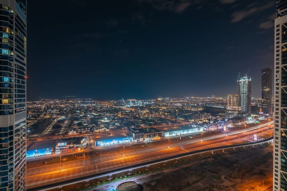 Experience the magic of Downtown Dubai at night from your private balcony, offering captivating city views with the iconic Burj Khalifa lit up in all its glory. A serene and stunning backdrop for a luxurious stay.