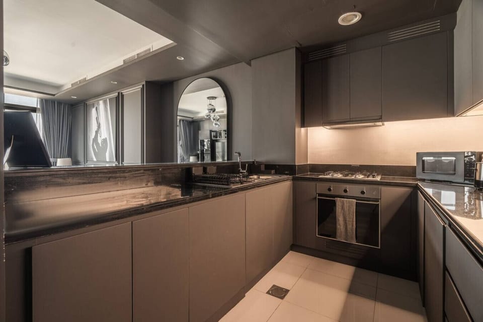 Fully equipped modern kitchen with high-end appliances, perfect for preparing meals during your stay. This spacious kitchen offers everything you need for a seamless experience in our luxury vacation home in Downtown Dubai.