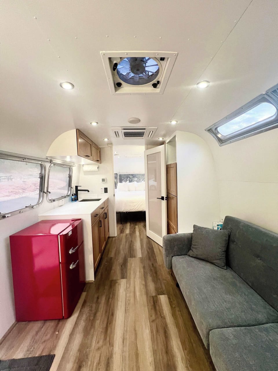 Airstream Dream kitchen and living area with cozy indoor seating, a kitchenette, and vintage-inspired glamping comfort for your Southern Utah stay.