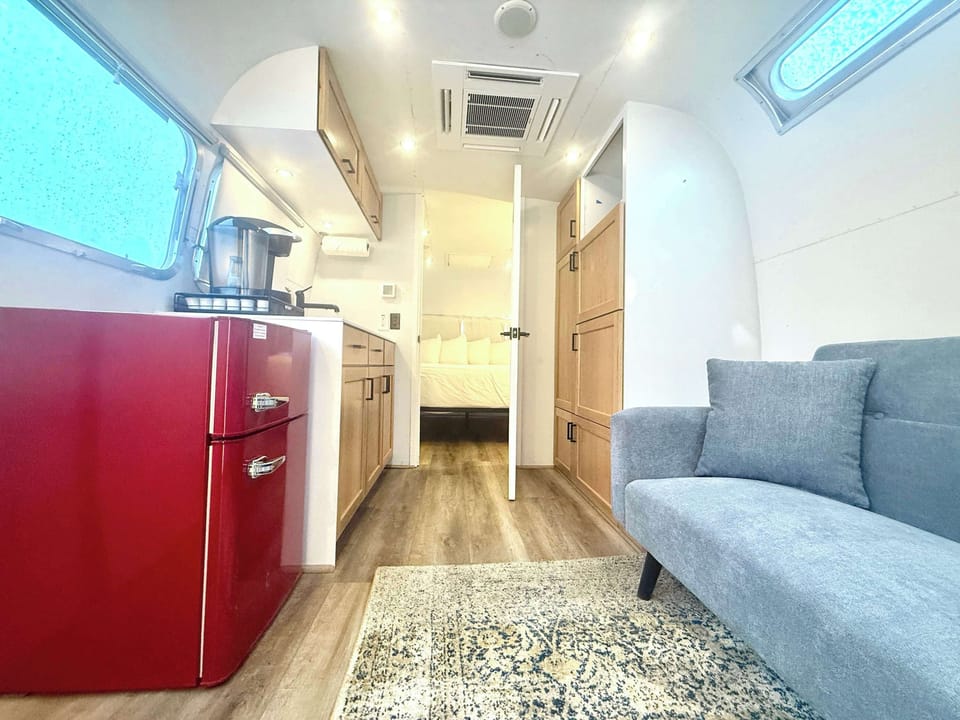 Kitchenette and sofa inside your Airstream glamping unit, giving you a cozy space for simple meals, morning coffee, and relaxing after Southern Utah adventures.