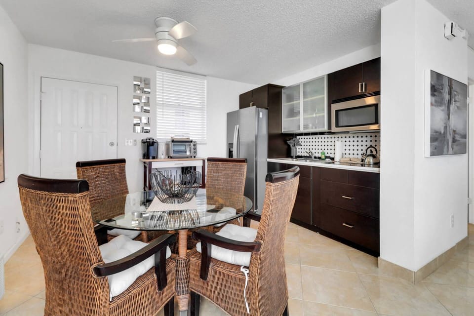 A dining table with seating for 4 is in the open kitchen.