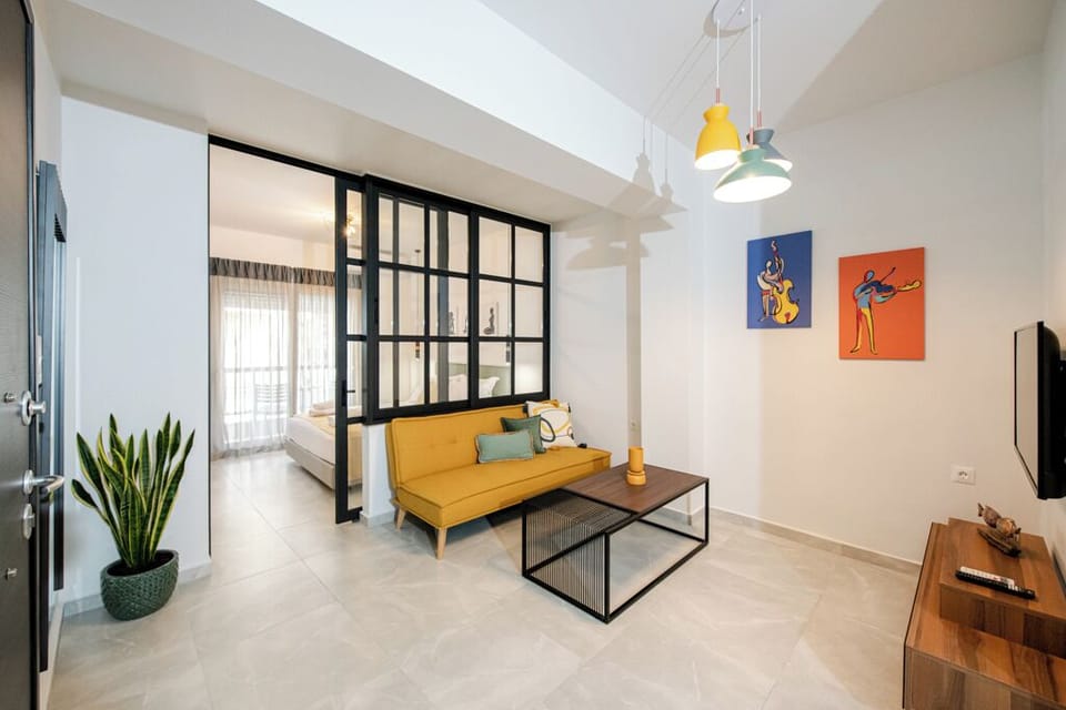 A bright open-plan living area with a mustard sofa and modern details.