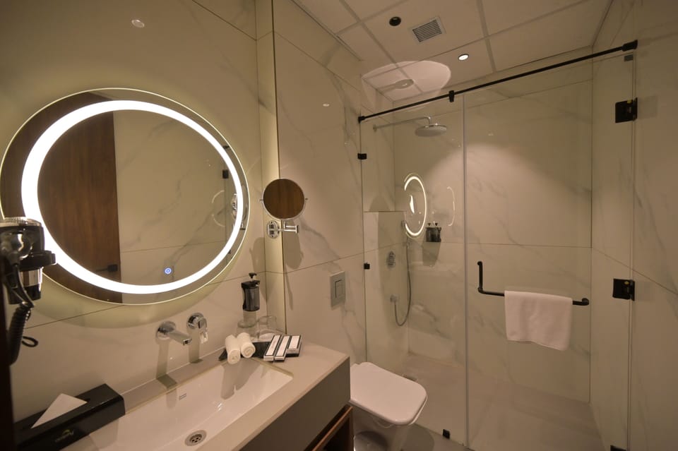 Deluxe Room, City View | Bathroom | Shower, slippers, soap, shampoo