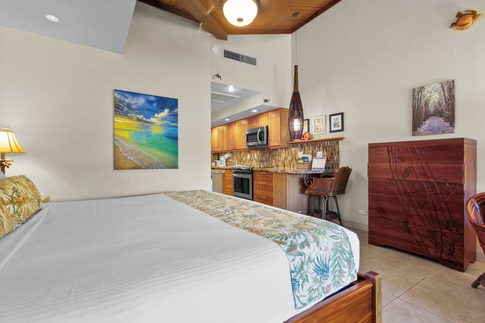 Sink into crisp linens beneath tropical-inspired décor, while your kitchenette with modern appliances and beautiful backsplash awaits your next meal.