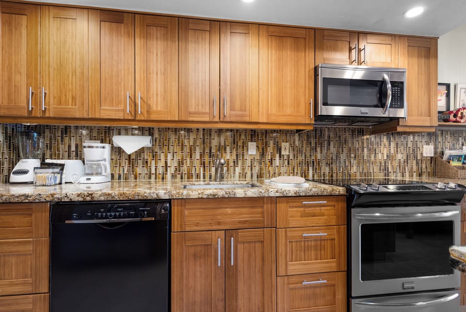 Prepare your favorite meals in this fully equipped kitchen with granite countertops, modern appliances, and warm wood cabinetry. Everything you need for home-cooked comfort during your stay.