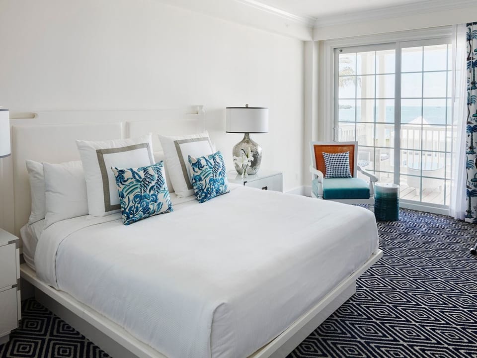 Cozy and refined bedroom with plush bedding and ocean-inspired accents, offering ultimate relaxation.