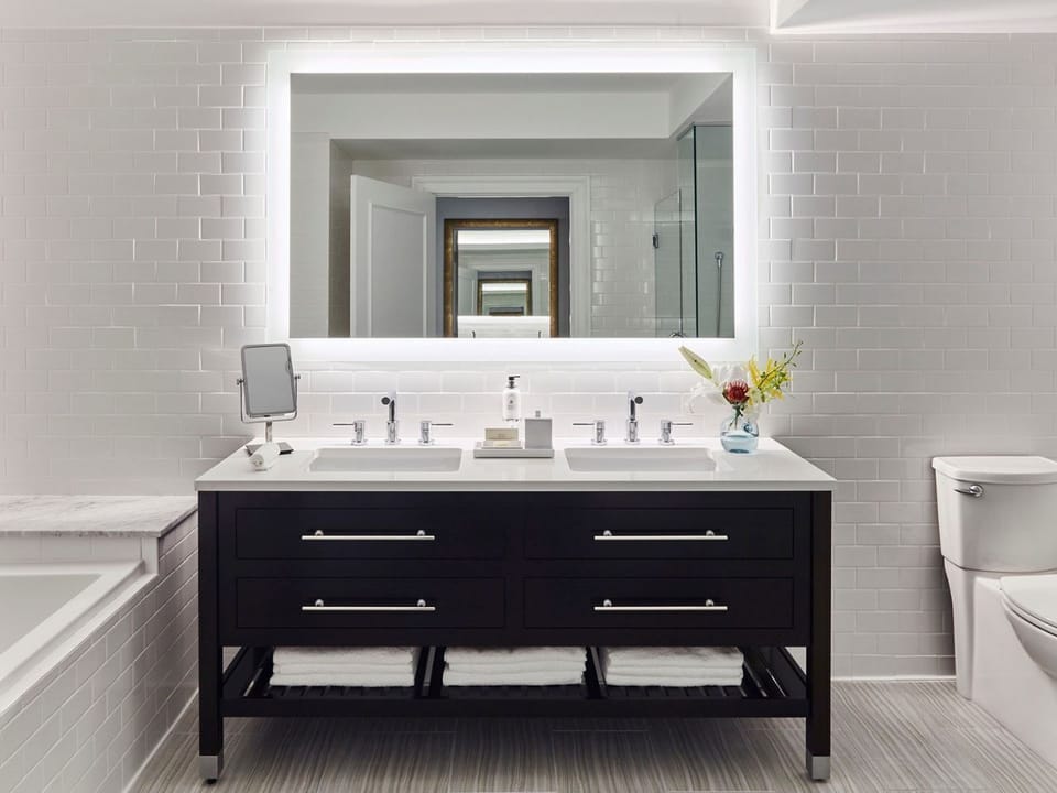 Spacious vanity area with soft lighting and modern touches, offering a serene start to your day.