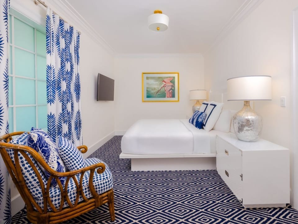 Bright and airy bedroom accented with coastal blues and cozy furnishings for a tranquil retreat.