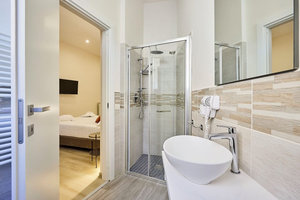 Deluxe Triple Room, Non Smoking, City View | Bathroom | Shower, hair dryer, slippers, towels