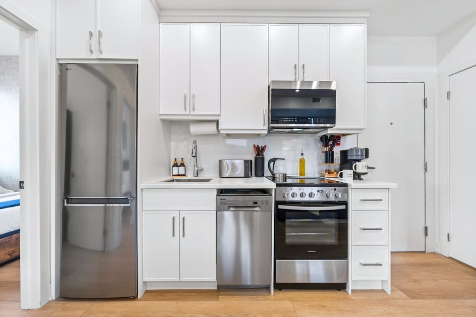 Fully equipped kitchen with stainless steel appliances.