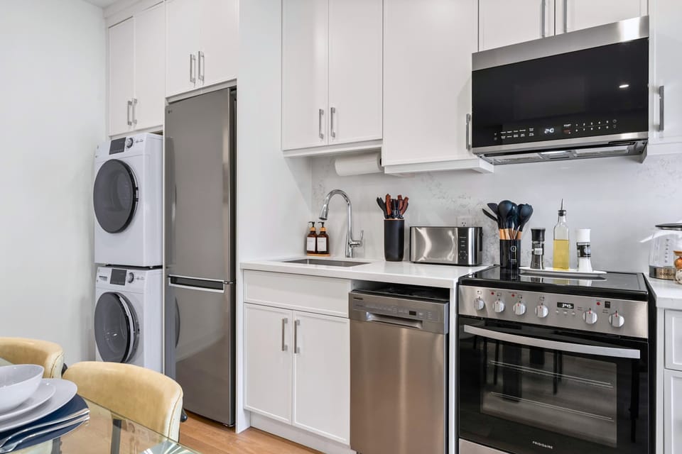 Fully equipped kitchen with modern stainless steel appliances.