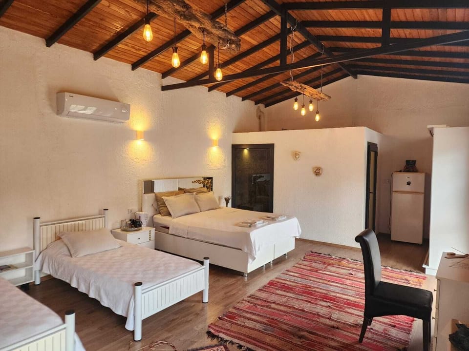 Quadruple Room, Garden View | Minibar, individually decorated, individually furnished