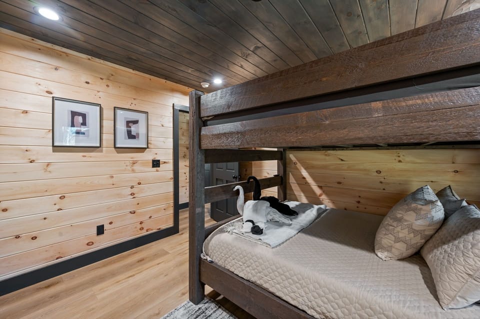 Queen bunk beds with en suite bathroom and TV.