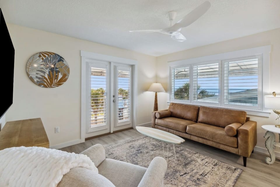 Lounge together as ocean breezes flow through bright windows.