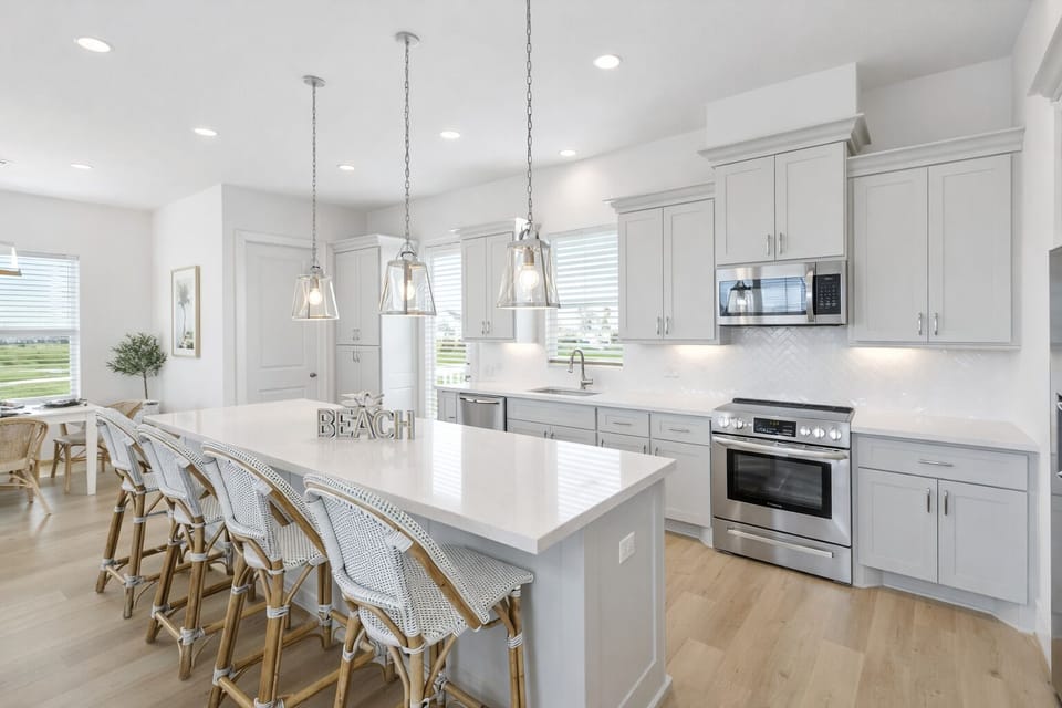 Fully equipped gourmet kitchen with large island, stainless steel appliances, and bar seating—ideal for entertaining in Galveston vacation rental.
