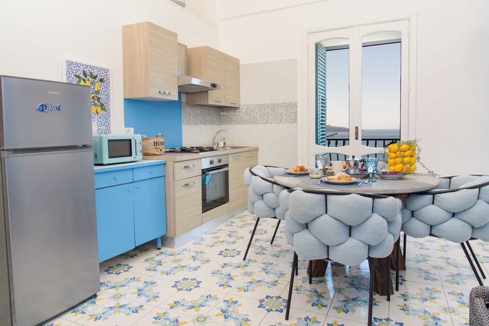 Panoramic Apartment, Balcony, Sea View | Private kitchen | Espresso maker, electric kettle, dining tables