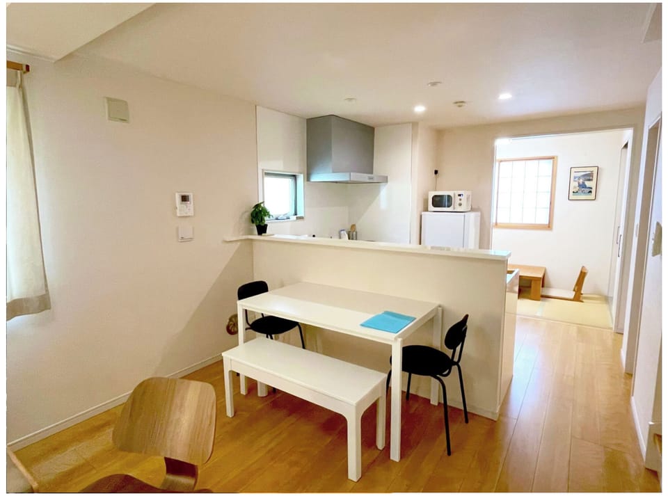 Western style dining area and view to kitchen and Japanese room