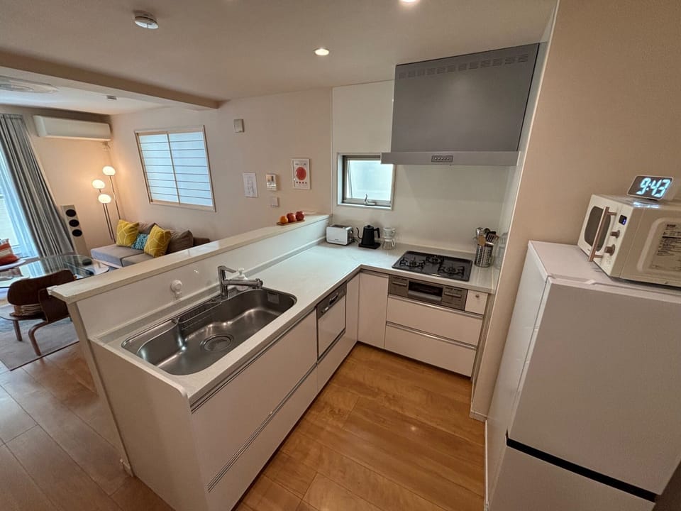 Kitchen with microwave, dishwasher, fridge/freezer, vent hood