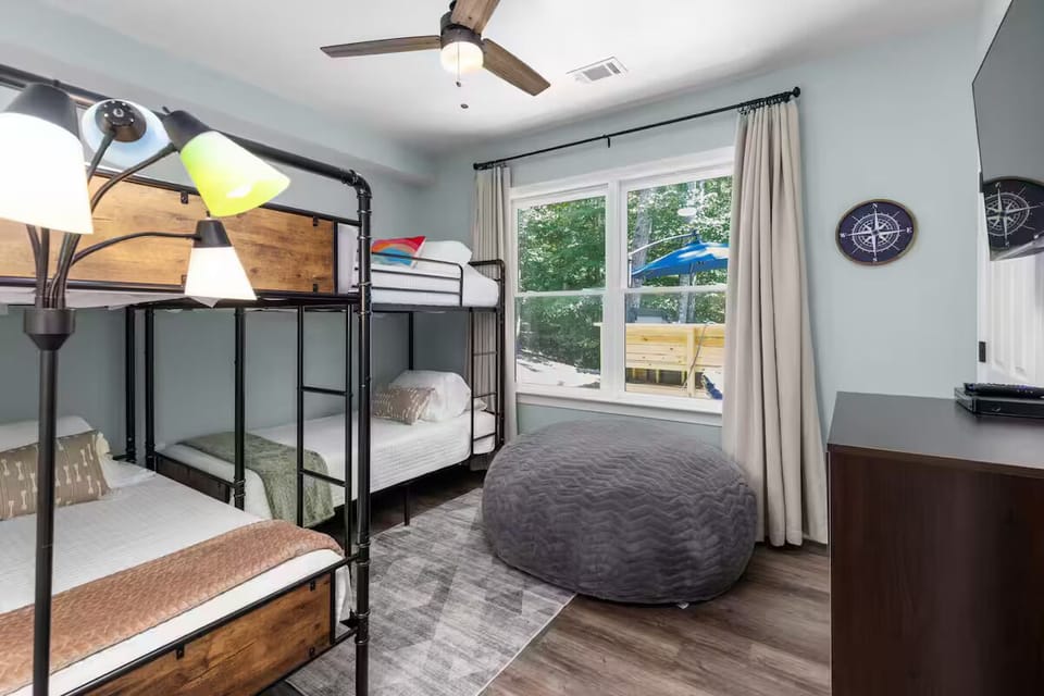 Bunk room with 2 sets of twin bunks, bean bag, Roku TV, & a small DVD collection