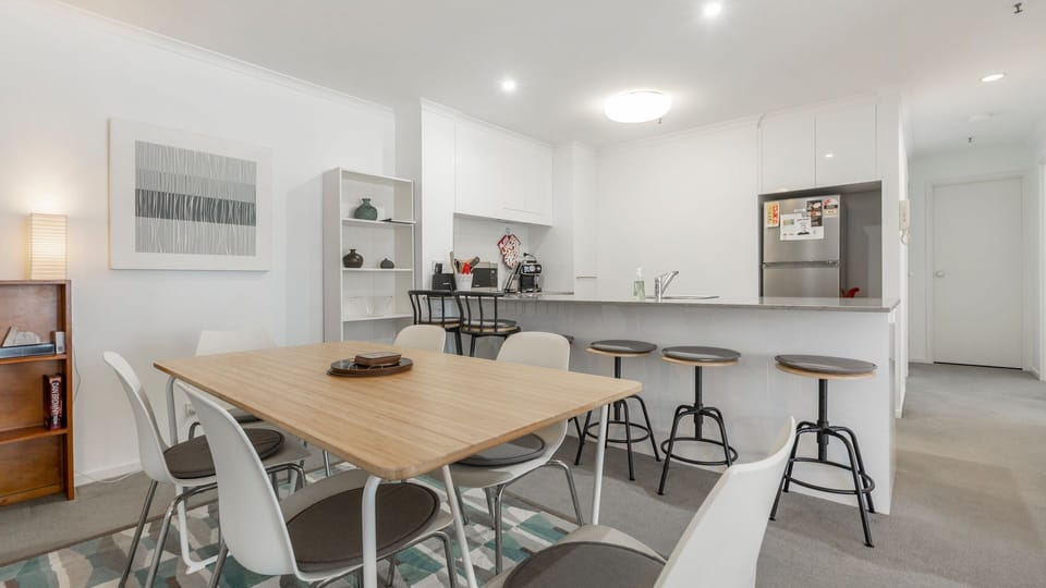 Open plan kitchen and dining space with modern appliances and a generous dining table for shared meals.