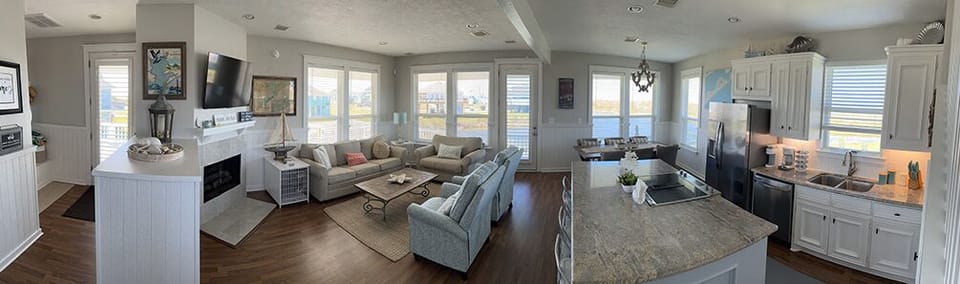 Panoramic view of entry, living, dining, and kitchen.
