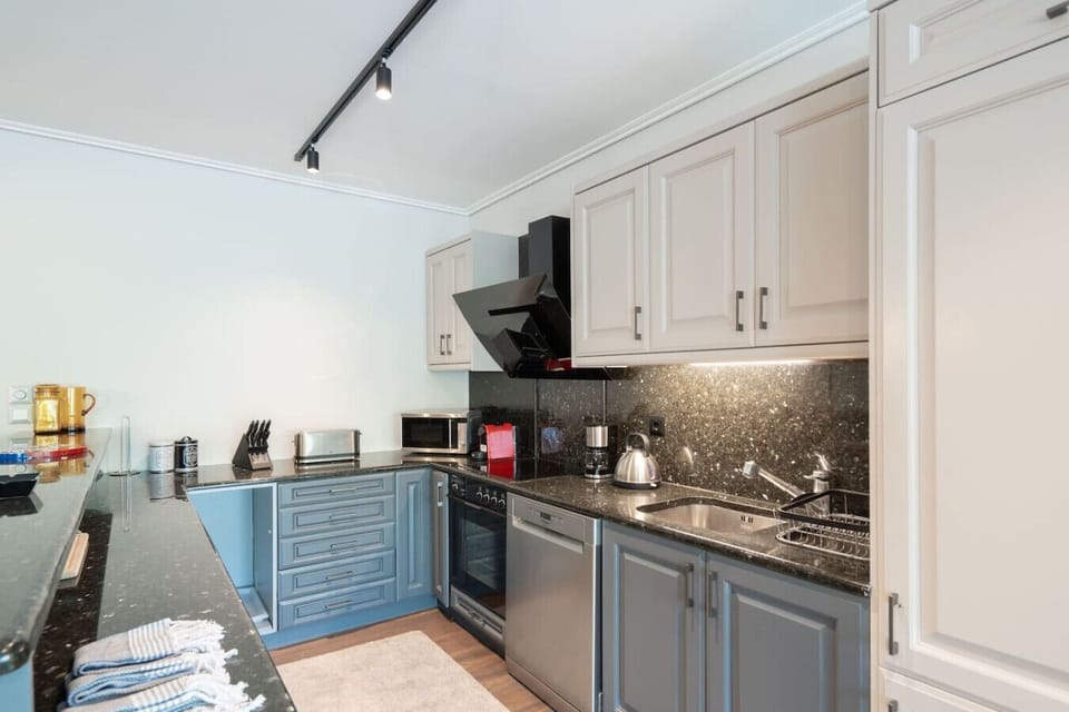 A closer look at the kitchen — Nespresso, kettle, knife block and induction hob. Designed for guests who actually cook. Booking.com tag: Kitchen or kitchenette