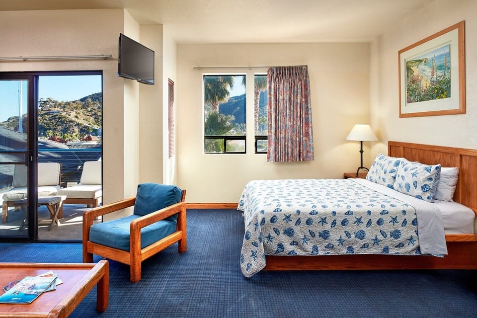 Unwind in a sunlit room with mountain-view balcony access.