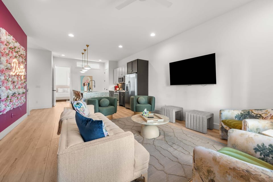 Open-concept living room and kitchen with modern decor.