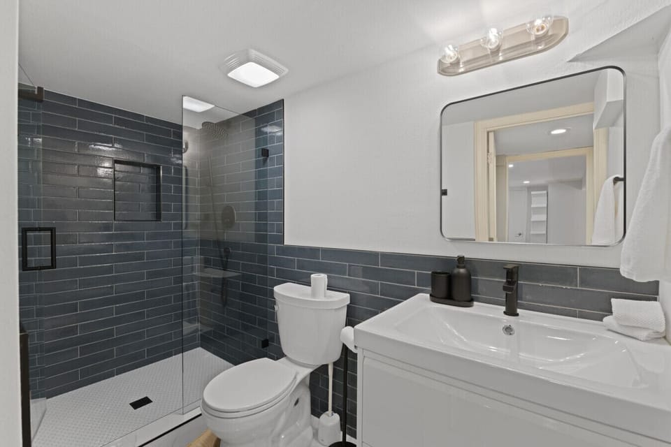 BATHROOM: The private bathroom features a full bath, spacious shower, toilet, quality fixtures, and plush towels. Essentials like shampoo, conditioner, and gel soap are provided for a refreshing and hassle-free stay.