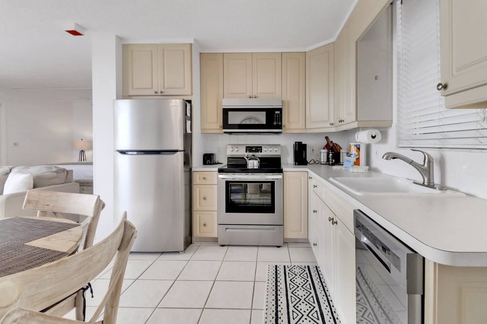 The full kitchen is equipped with refrigerator/freezer, oven, microwave, and dishwasher.